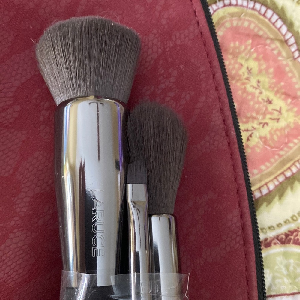 Three beautiful Laruce brushes, one kabuki, one small angle, and a highlighter